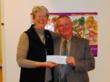 Mary Meyer of Kids Cook! accepts a check from AAM's Ken Inskeep.